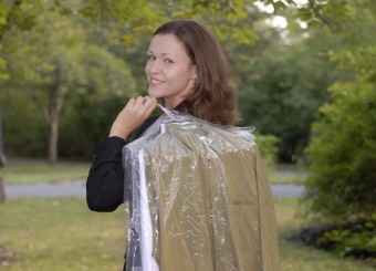 Woman Holding Dry Cleaning